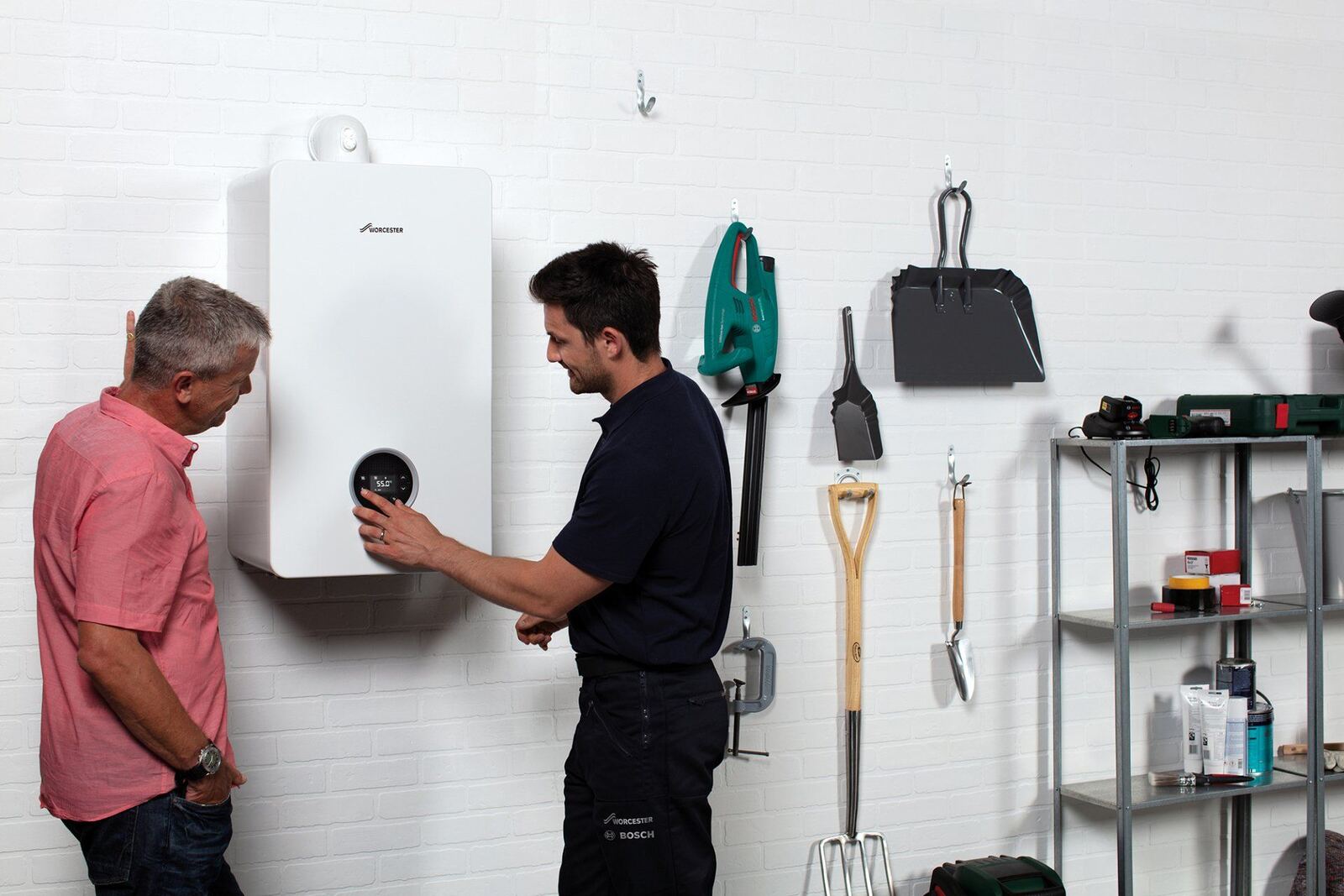 A homeowner being shown her new boiler in the kitchen